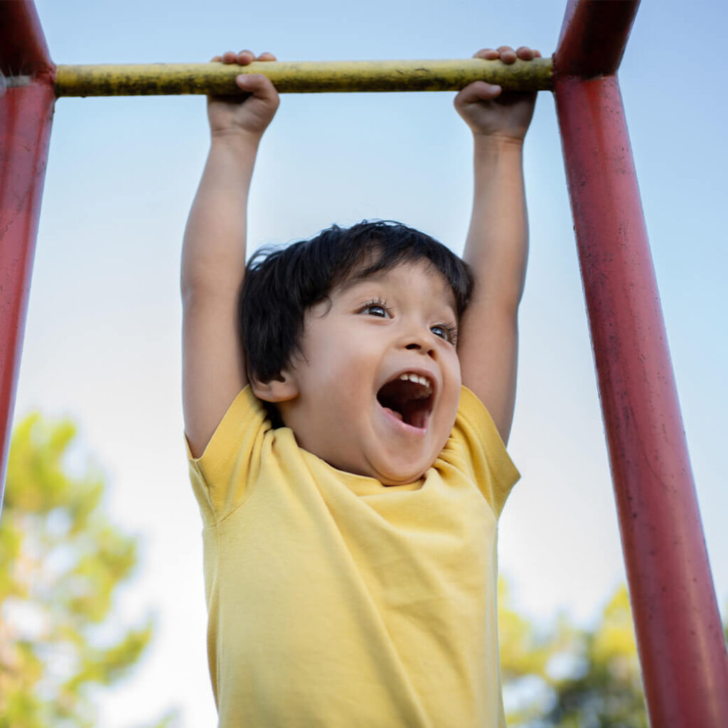 Little boy having fun at playground.